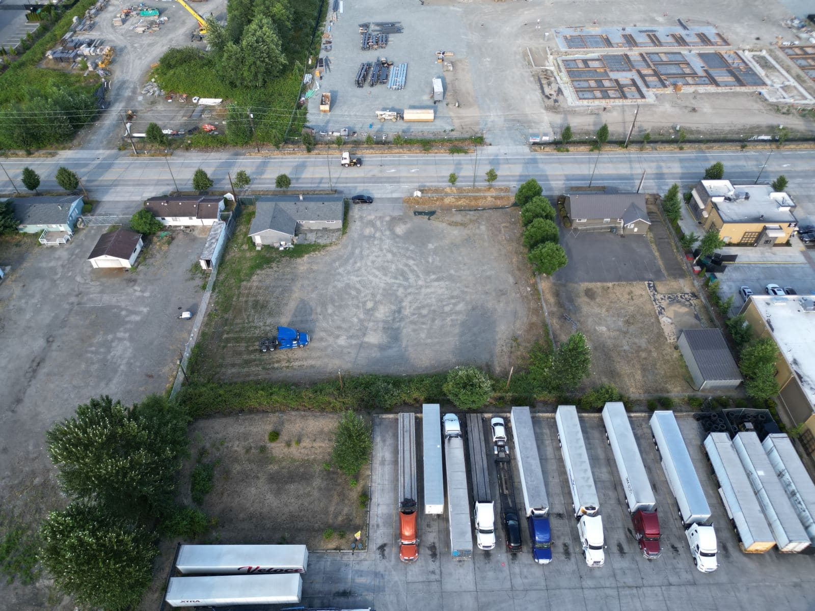 Drone view of the Sumner yard beside the road, with trailers and trucks parked